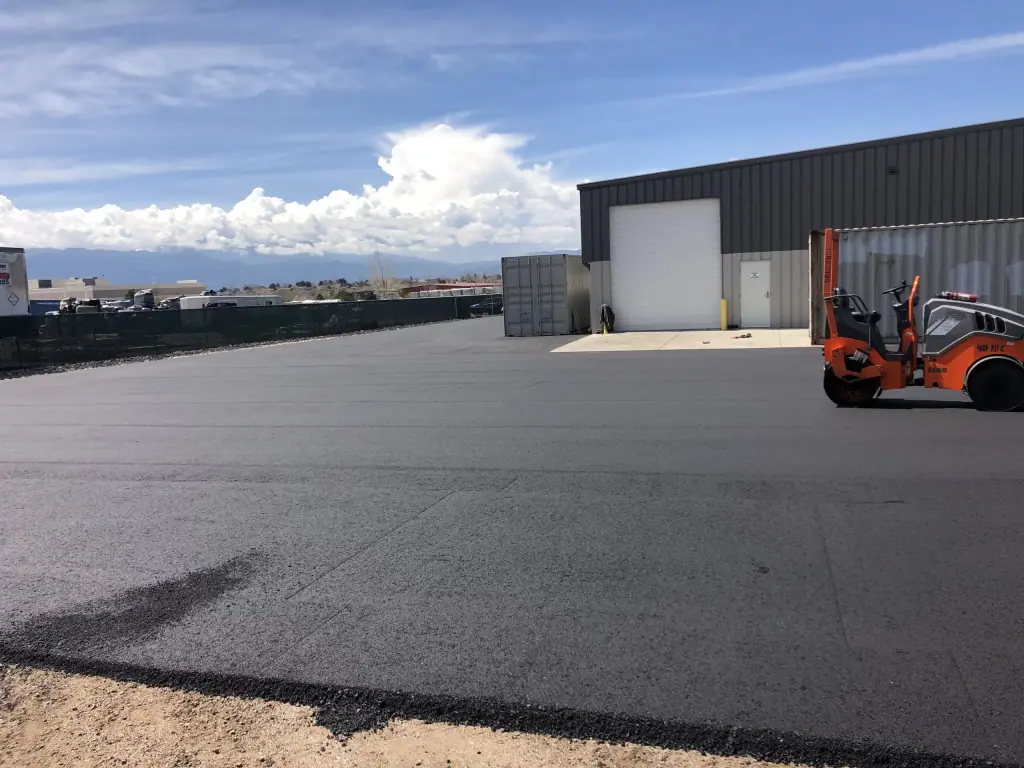 New asphalt lot beside a warehouse