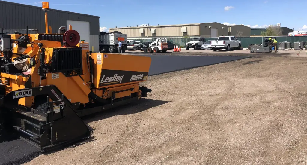 LeeBoy paver laying fresh asphalt on a commercial lot